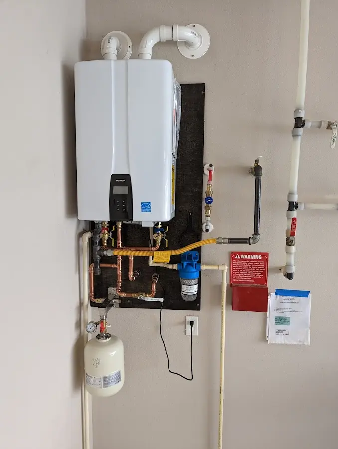 Professional plumber installing copper piping in a Old Westbury home